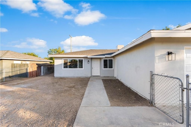 1534 Richfield Ave, Rosamond, CA 93560 - property entrance featuring a gate and stucco siding