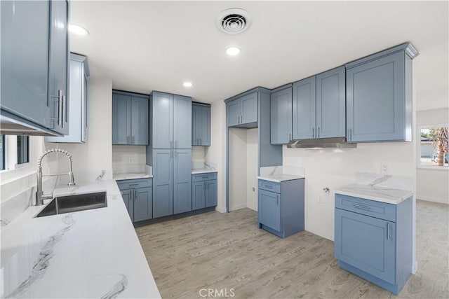 1534 Richfield Ave, Rosamond, CA 93560 - kitchen with light wood-style flooring, light stone counters, and recessed lighting