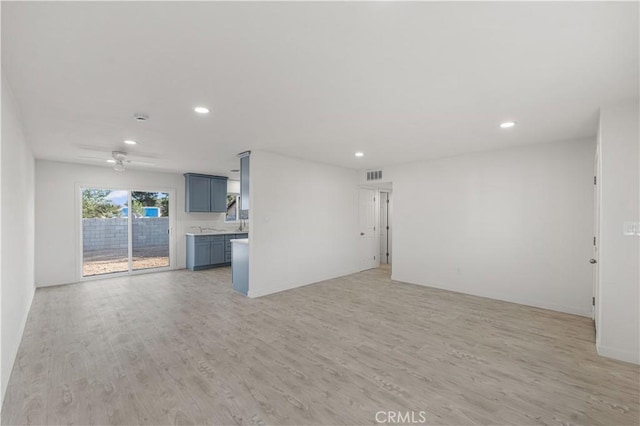 1534 Richfield Ave, Rosamond, CA 93560 - unfurnished living room with light wood-style flooring and recessed lighting