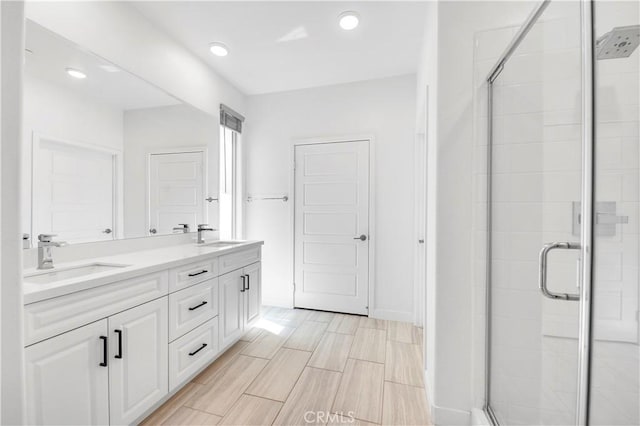 1660 Capri Way, Beaumont, CA 92223 - bathroom with a shower stall, double vanity, and recessed lighting