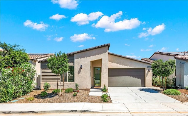1660 Capri Way, Beaumont, CA 92223 - view of front of home featuring stucco siding, a garage, driveway, and a tiled roof
