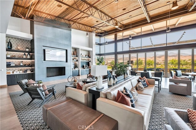 1660 Capri Way, Beaumont, CA 92223 - living area with a high ceiling, a fireplace, bar, built in features, and wooden ceiling