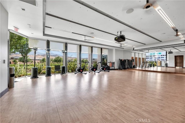 1660 Capri Way, Beaumont, CA 92223 - exercise room featuring wood finished floors and expansive windows