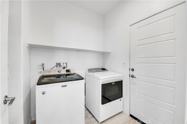 1660 Capri Way, Beaumont, CA 92223 - washroom featuring washer and clothes dryer and light wood-type flooring