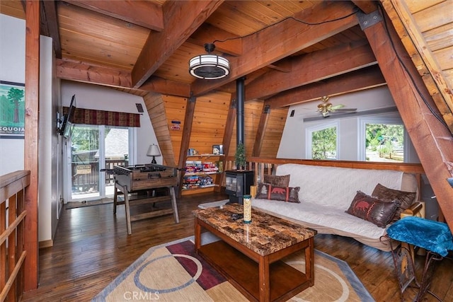 52926 Balsam Dr, Oakhurst, CA 93644 - living area with a wooden ceiling with exposed beams, a wood stove, healthy amount of natural light, and hardwood / wood-style floors