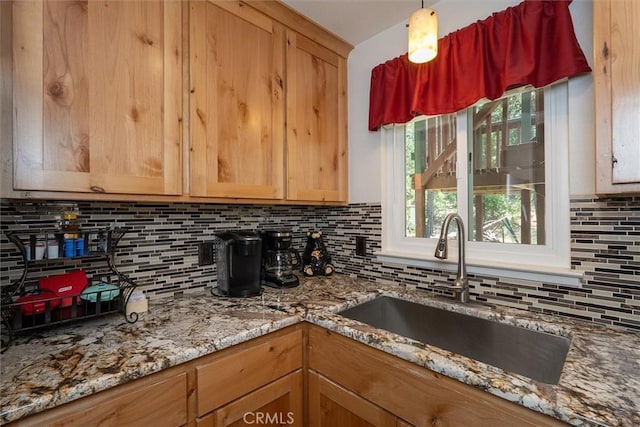 52926 Balsam Dr, Oakhurst, CA 93644 - kitchen with tasteful backsplash, light stone countertops, and hanging light fixtures