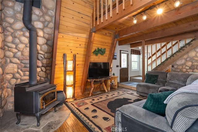 52926 Balsam Dr, Oakhurst, CA 93644 - living area featuring wood-type flooring, a wood stove, wooden walls, stairs, and track lighting