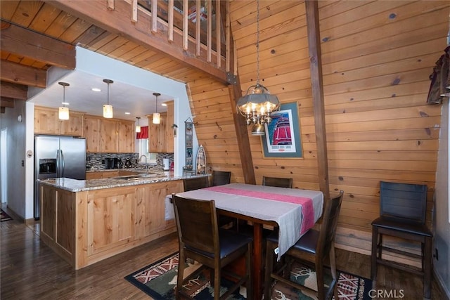 52926 Balsam Dr, Oakhurst, CA 93644 - dining area featuring dark wood-type flooring, a chandelier, wooden walls, and beamed ceiling