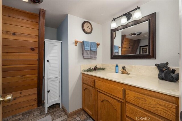 52926 Balsam Dr, Oakhurst, CA 93644 - bathroom with vanity, a closet, and stone finish floors