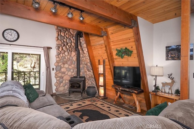 52926 Balsam Dr, Oakhurst, CA 93644 - living room with a wood stove, a wood ceiling with exposed beams, and track lighting