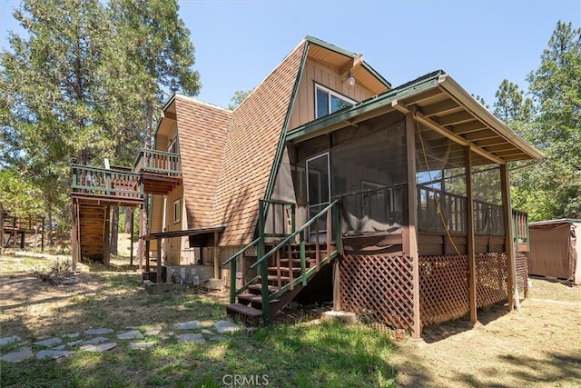 52926 Balsam Dr, Oakhurst, CA 93644 - back of property with stairway, a sunroom, a shingled roof, and a wooden deck