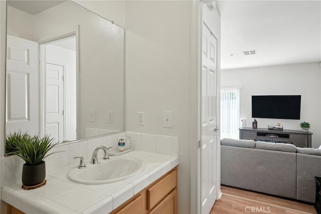 8554 Burnet Ave Unit 144, North Hills, CA 91343 - bathroom with vanity and wood finished floors