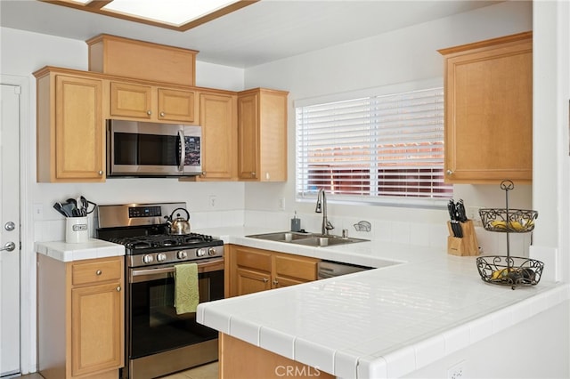 8554 Burnet Ave Unit 144, North Hills, CA 91343 - kitchen with appliances with stainless steel finishes, a peninsula, light brown cabinetry, and tile countertops