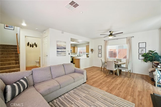 8554 Burnet Ave Unit 144, North Hills, CA 91343 - living area featuring ceiling fan, stairway, and light wood-style floors