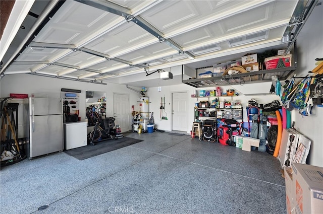 8554 Burnet Ave Unit 144, North Hills, CA 91343 - garage featuring freestanding refrigerator and a garage door opener
