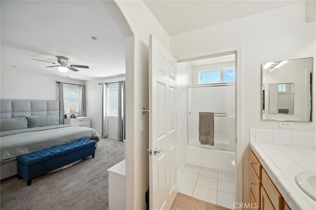 8554 Burnet Ave Unit 144, North Hills, CA 91343 - bedroom with arched walkways, multiple windows, light colored carpet, and light tile patterned floors