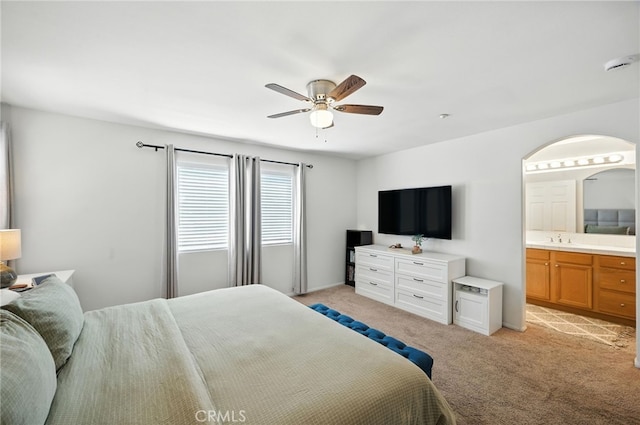 8554 Burnet Ave Unit 144, North Hills, CA 91343 - bedroom featuring light carpet, connected bathroom, arched walkways, and ceiling fan