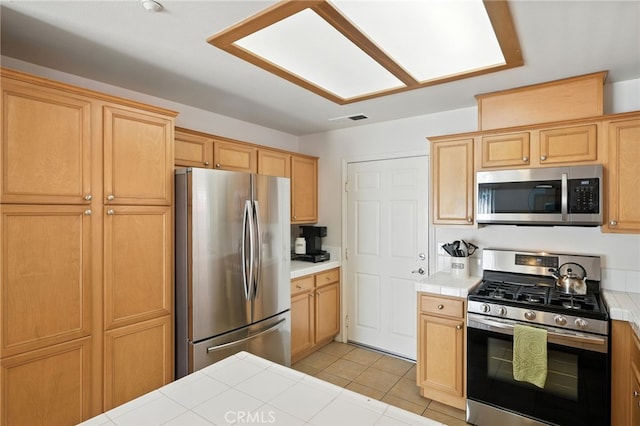 8554 Burnet Ave Unit 144, North Hills, CA 91343 - kitchen featuring tile countertops, appliances with stainless steel finishes, and light tile patterned floors