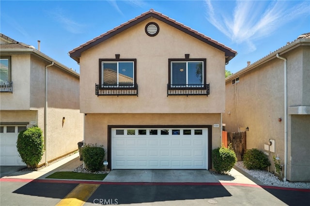 8554 Burnet Ave Unit 144, North Hills, CA 91343 - mediterranean / spanish home with stucco siding, a garage, and driveway