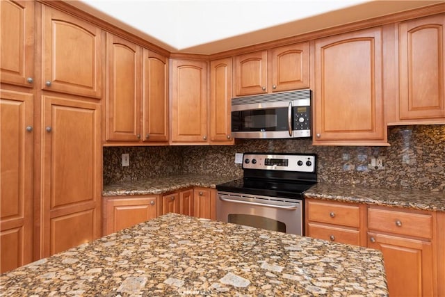 13341 Twin Hls Unit 57C, Seal Beach, CA 90740 - kitchen with stainless steel appliances, dark stone countertops, and decorative backsplash
