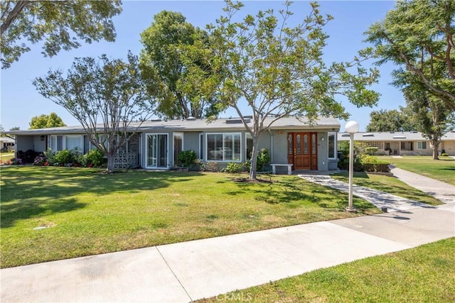 13341 Twin Hls Unit 57C, Seal Beach, CA 90740 - ranch-style home with a front yard, solar panels, and stucco siding
