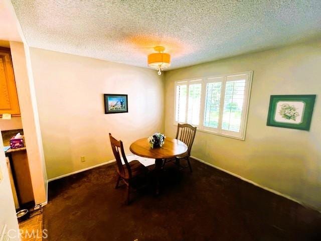 13212 La Jolla Cir Unit 307B, La Mirada, CA 90638 - dining room featuring a textured ceiling and carpet