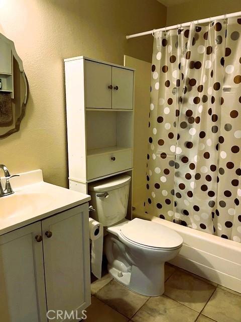13212 La Jolla Cir Unit 307B, La Mirada, CA 90638 - full bathroom with vanity, shower / bath combo, tile patterned flooring, and a textured wall