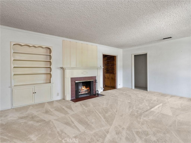 10348 Woodbridge St, Toluca Lake, CA 91602 - unfurnished living room with a textured ceiling, carpet floors, a fireplace, built in shelves, and crown molding