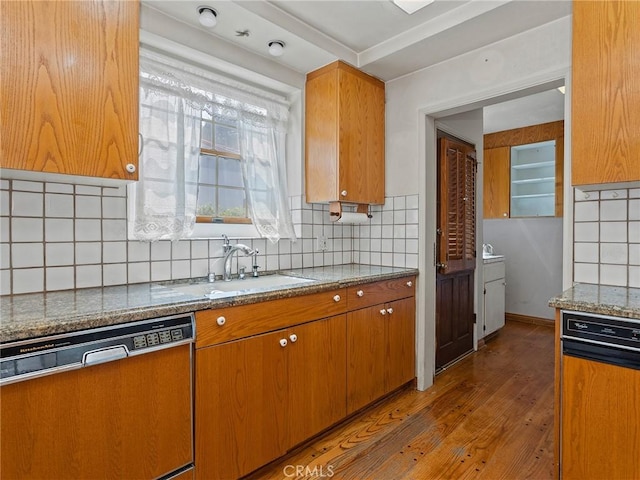 10348 Woodbridge St, Toluca Lake, CA 91602 - kitchen with dishwashing machine, light wood-type flooring, stone counters, brown cabinetry, and tasteful backsplash