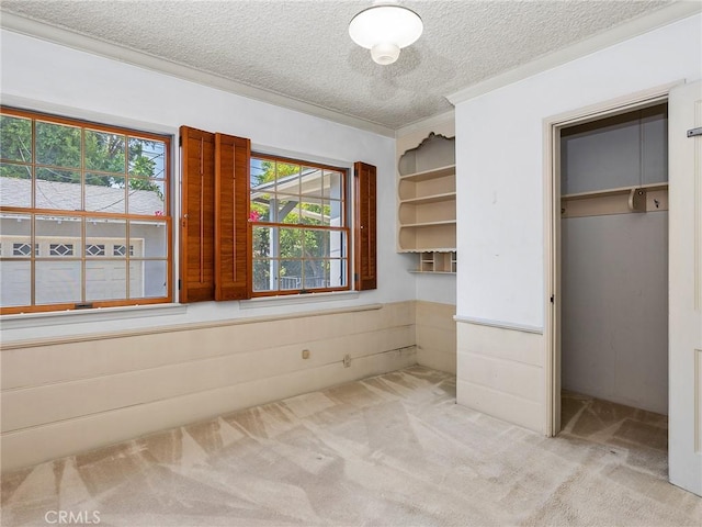 10348 Woodbridge St, Toluca Lake, CA 91602 - unfurnished bedroom featuring carpet flooring, a textured ceiling, and a wainscoted wall