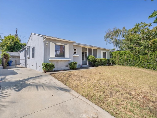 10348 Woodbridge St, Toluca Lake, CA 91602 - view of front of house featuring crawl space, driveway, a front lawn, and stucco siding