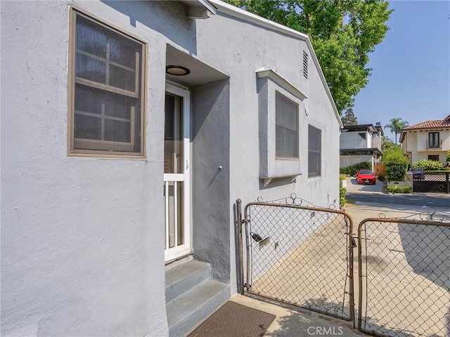 10348 Woodbridge St, Toluca Lake, CA 91602 - property entrance with a gate and stucco siding