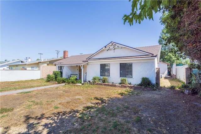 16533 Nordhoff St, North Hills, CA 91343 - view of front of home with stucco siding and a chimney