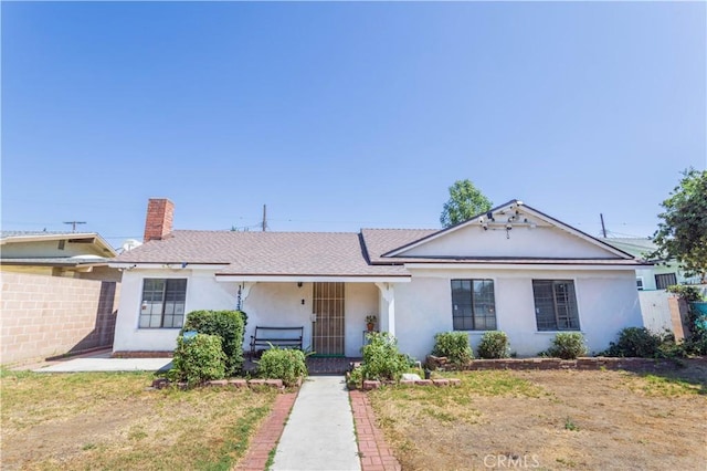 16533 Nordhoff St, North Hills, CA 91343 - ranch-style house with stucco siding, a chimney, a shingled roof, and a porch