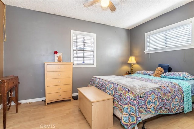 16533 Nordhoff St, North Hills, CA 91343 - bedroom with light wood-type flooring, multiple windows, a textured ceiling, and ceiling fan