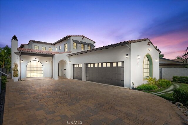 6204 Oak Ave, Temple City, CA 91780 - mediterranean / spanish house featuring stucco siding, a tile roof, a garage, a chimney, and decorative driveway