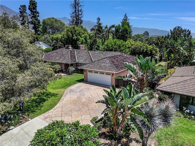 1310 Santa Margarita Dr, Arcadia, CA 91006 - view of front of home featuring an attached garage, concrete driveway, a front lawn, a mountain view, and a chimney