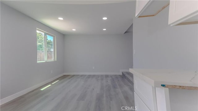 460 E 2nd St, San Jacinto, CA 92583 - unfurnished living room with recessed lighting and light wood-style flooring