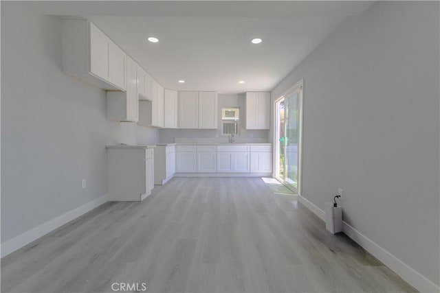 460 E 2nd St, San Jacinto, CA 92583 - kitchen with white cabinets, light wood finished floors, and recessed lighting
