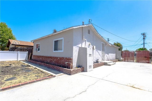 460 E 2nd St, San Jacinto, CA 92583 - view of home's exterior featuring stucco siding, brick siding, a patio area, and driveway