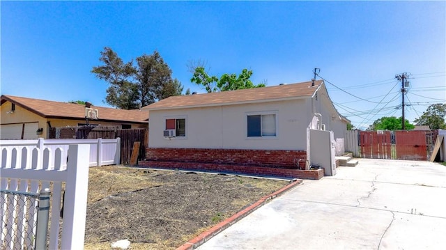 460 E 2nd St, San Jacinto, CA 92583 - view of side of home featuring brick siding, stucco siding, and a patio area