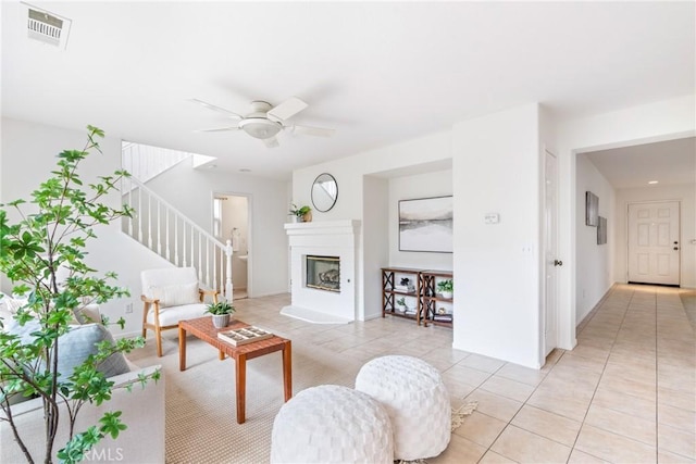 391 Franciscan Way, Oceanside, CA 92057 - living area with light tile patterned flooring, stairs, a ceiling fan, and a glass covered fireplace