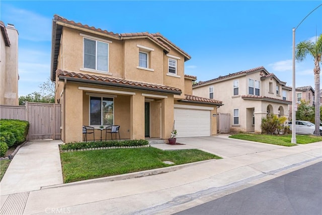 391 Franciscan Way, Oceanside, CA 92057 - mediterranean / spanish house with stucco siding, a gate, concrete driveway, a garage, and a porch