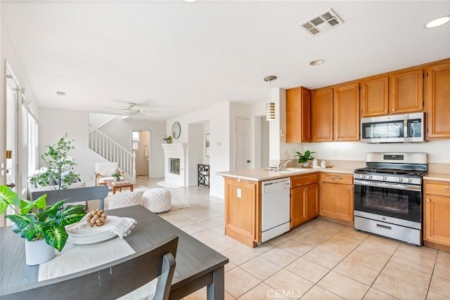 391 Franciscan Way, Oceanside, CA 92057 - kitchen featuring stainless steel appliances, light tile patterned flooring, light countertops, a peninsula, and recessed lighting