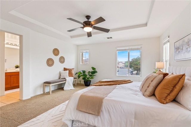 391 Franciscan Way, Oceanside, CA 92057 - bedroom featuring a tray ceiling, light colored carpet, ensuite bathroom, and a ceiling fan