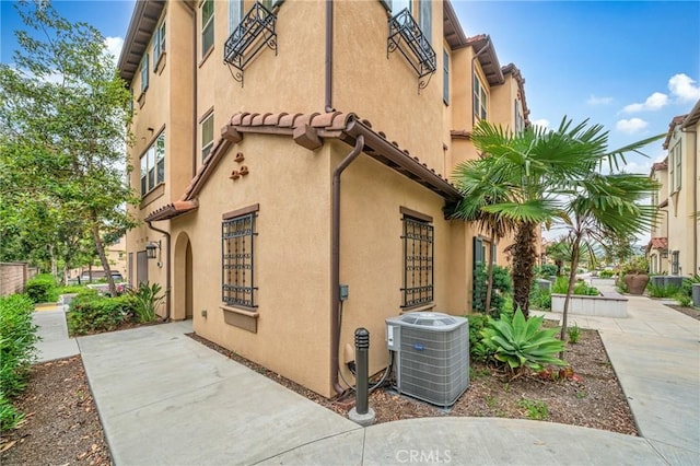 20950 Cornerstone Dr, Walnut, CA 91789 - view of side of home with a central air condition unit and stucco siding