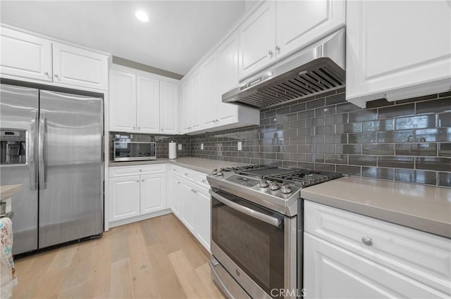 20950 Cornerstone Dr, Walnut, CA 91789 - kitchen with stainless steel appliances, under cabinet range hood, white cabinets, light wood-style flooring, and backsplash