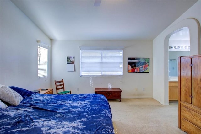 1166 Labrador Ct, Newman, CA 95360 - bedroom featuring arched walkways, carpet, ensuite bathroom, and ceiling fan