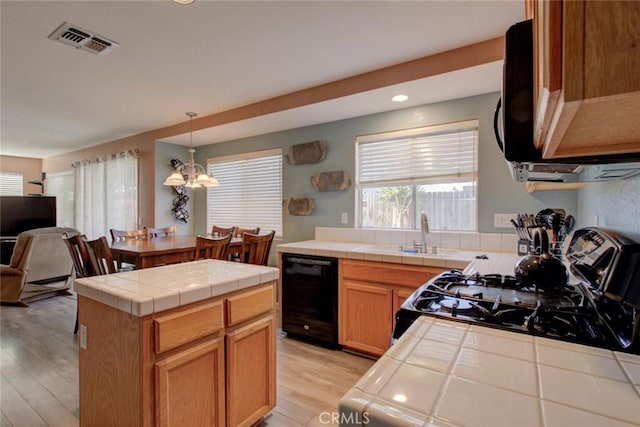 1166 Labrador Ct, Newman, CA 95360 - kitchen with tile counters, plenty of natural light, dishwasher, and recessed lighting