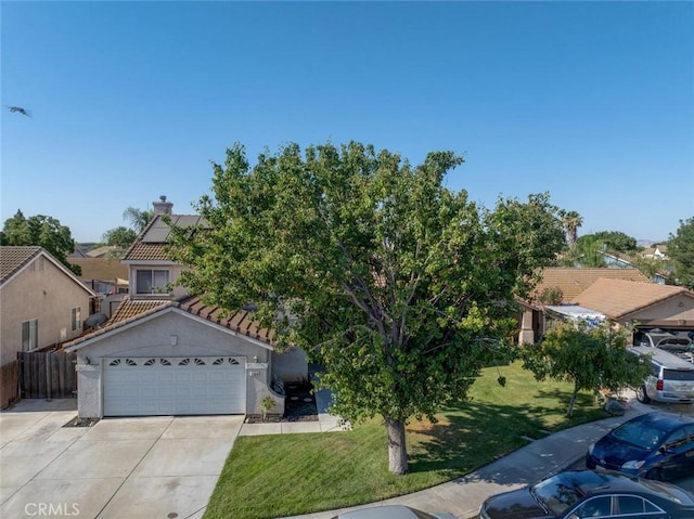 1166 Labrador Ct, Newman, CA 95360 - view of front of home with driveway, a chimney, a tiled roof, a garage, and stucco siding